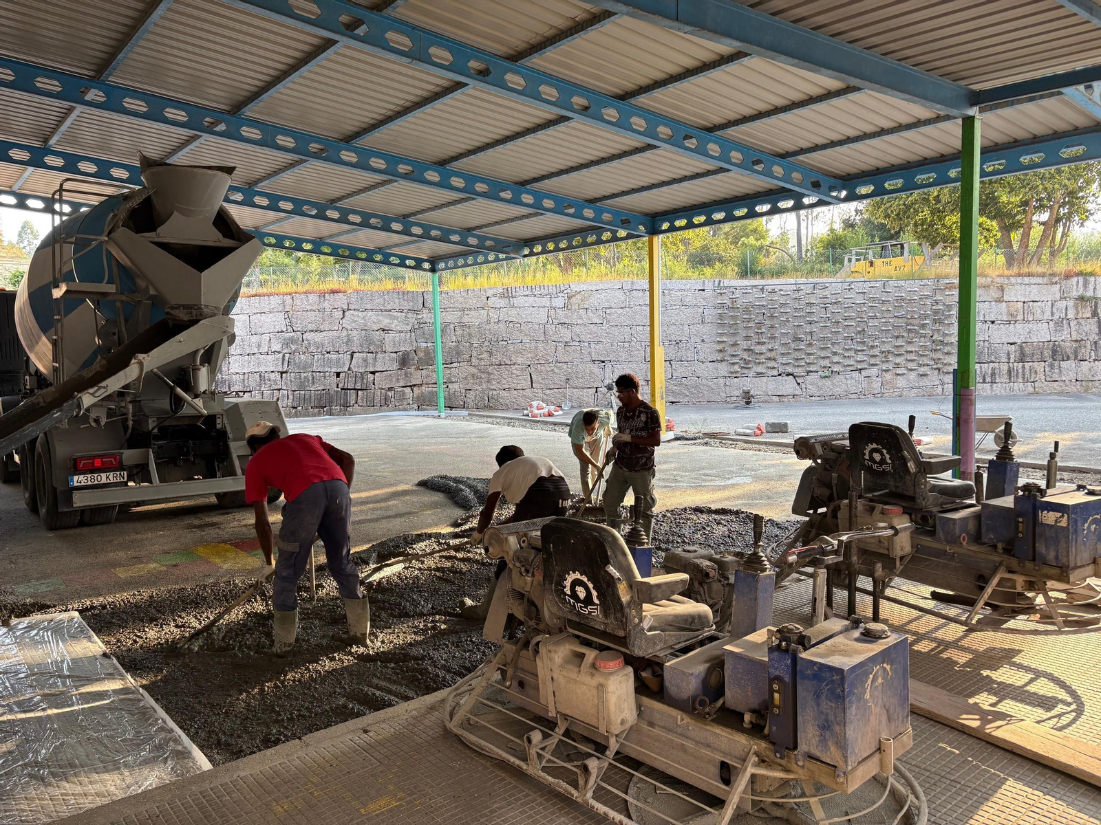 Obreros trabajando en el hormigonado y pulido de una de las pistas cubiertas de uno de los centros.